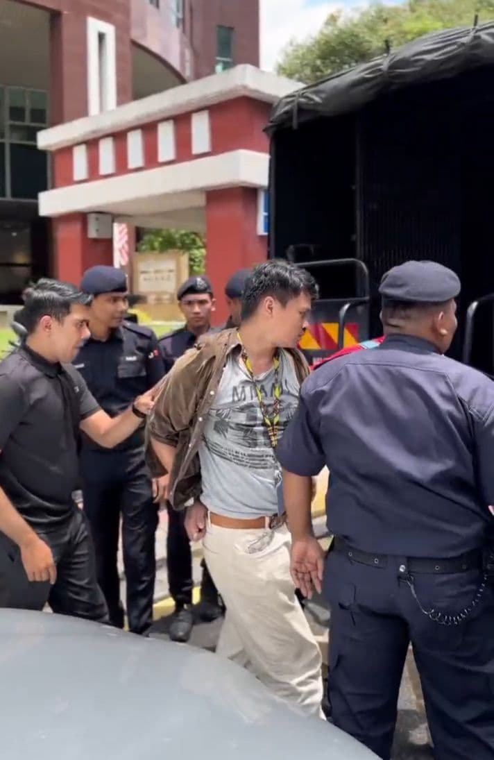 An activist being detained by Malaysian police.