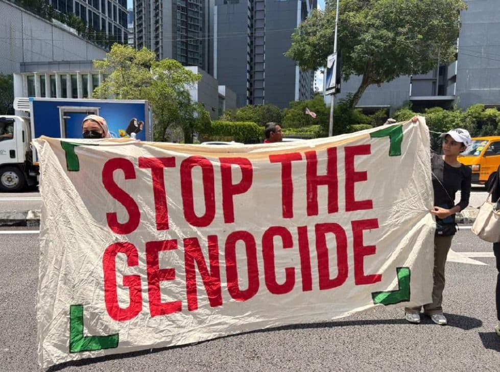Protestors hold banner stop the genocide